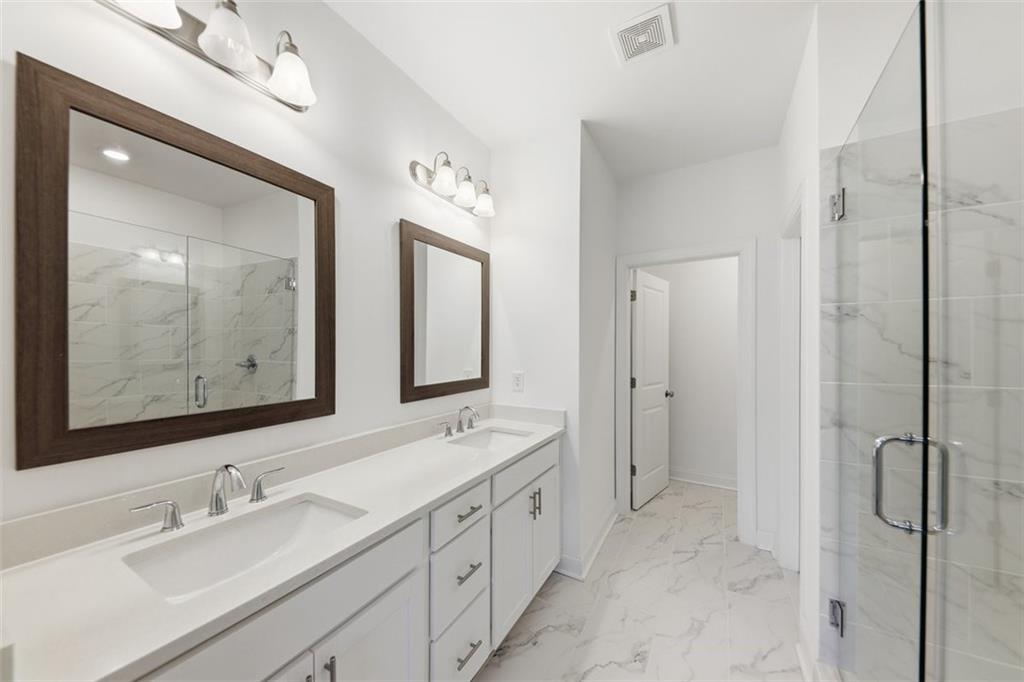 3193 Bartee Walk Suwanee, GA 30024 - Photo 15 of 27 a bathroom with a double vanity sink mirror and double
