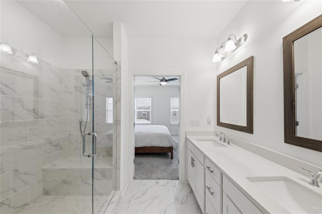 3193 Bartee Walk Suwanee, GA 30024 - Photo 16 of 27 a bathroom with a double vanity sink mirror and shower