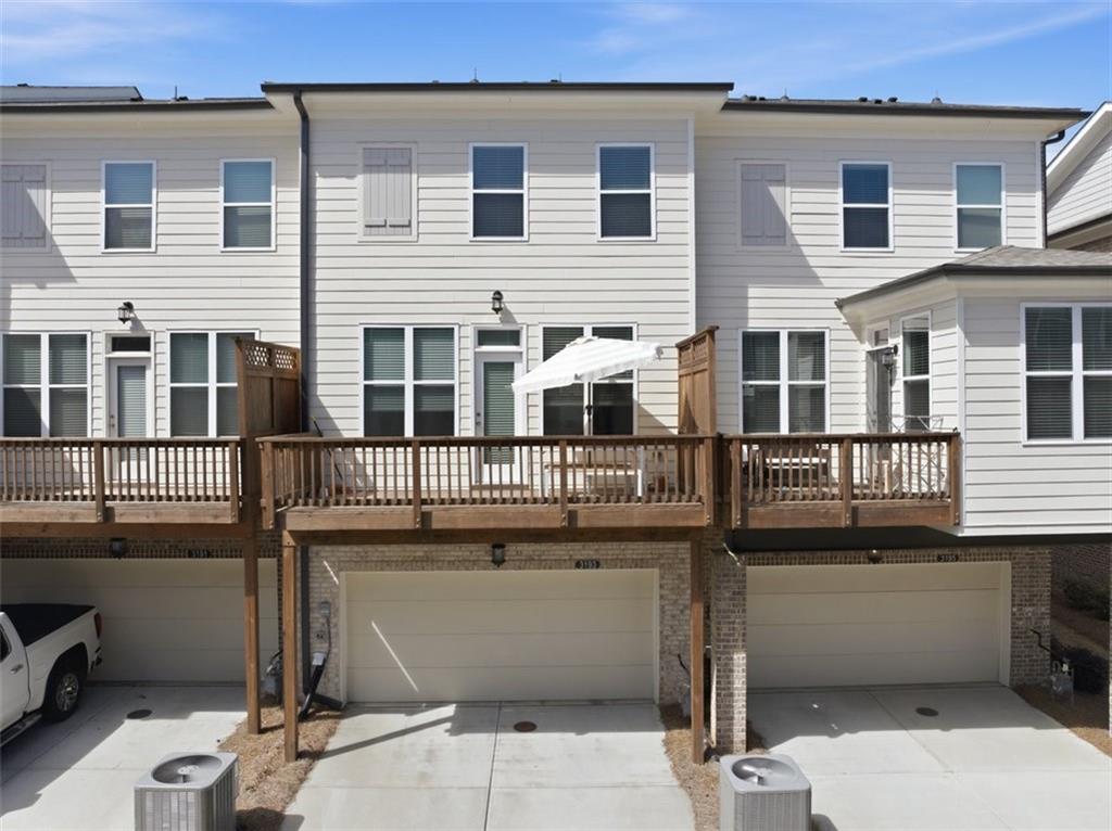 3193 Bartee Walk Suwanee, GA 30024 - Photo 22 of 27 a front view of a house with a garage