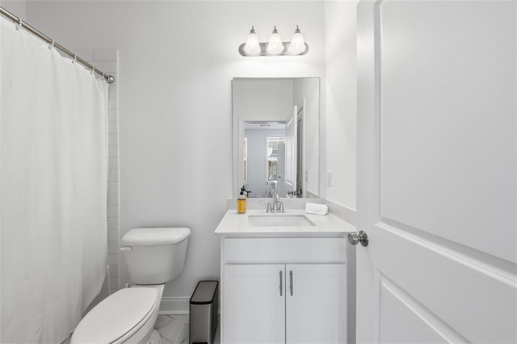 3193 Bartee Walk Suwanee, GA 30024 - Photo 4 of 27 a bathroom with a sink toilet and mirror
