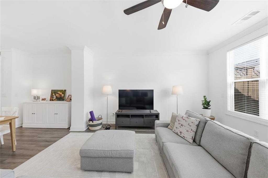 3193 Bartee Walk Suwanee, GA 30024 - Photo 6 of 27 a living room with furniture and a flat screen tv