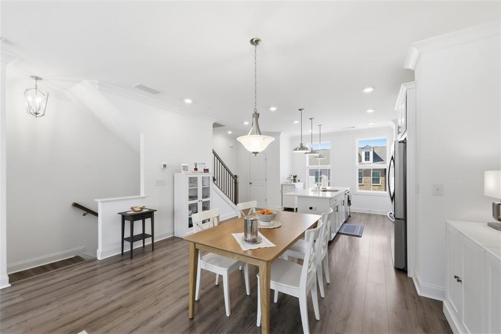 3193 Bartee Walk Suwanee, GA 30024 - Photo 8 of 27 a dining room with furniture and wooden floor