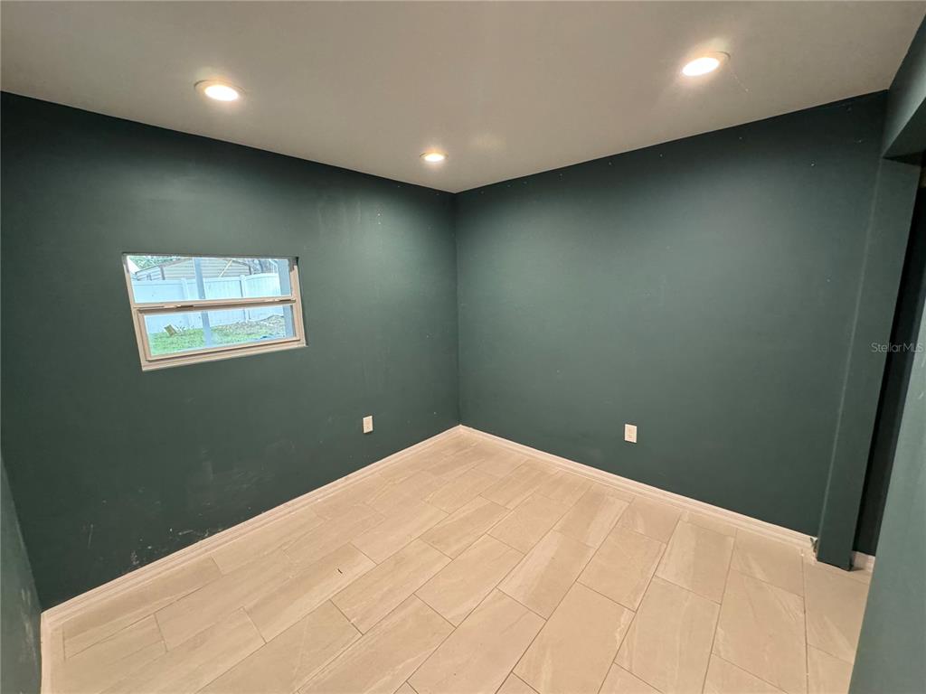 7102 Reindeer Road Tampa, FL 33619 - Photo 11 of 25 an empty room with windows