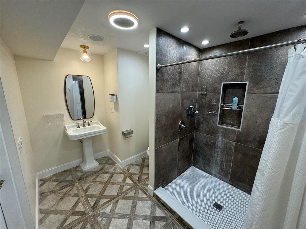7102 Reindeer Road Tampa, FL 33619 - Photo 13 of 25 a bathroom with a sink toilet and shower