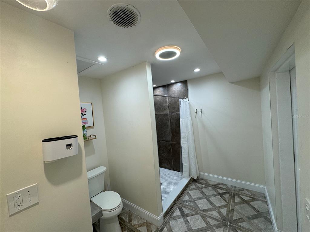 7102 Reindeer Road Tampa, FL 33619 - Photo 14 of 25 a bathroom with a toilet and a shower