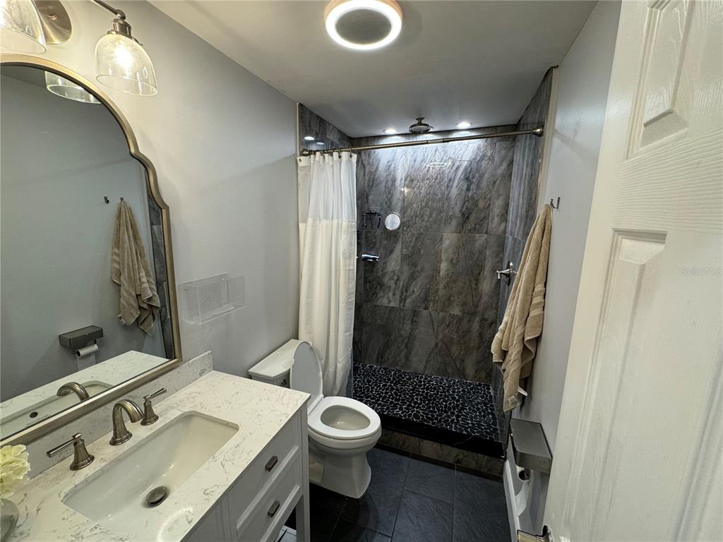 7102 Reindeer Road Tampa, FL 33619 - Photo 15 of 25 a bathroom with a sink toilet and shower