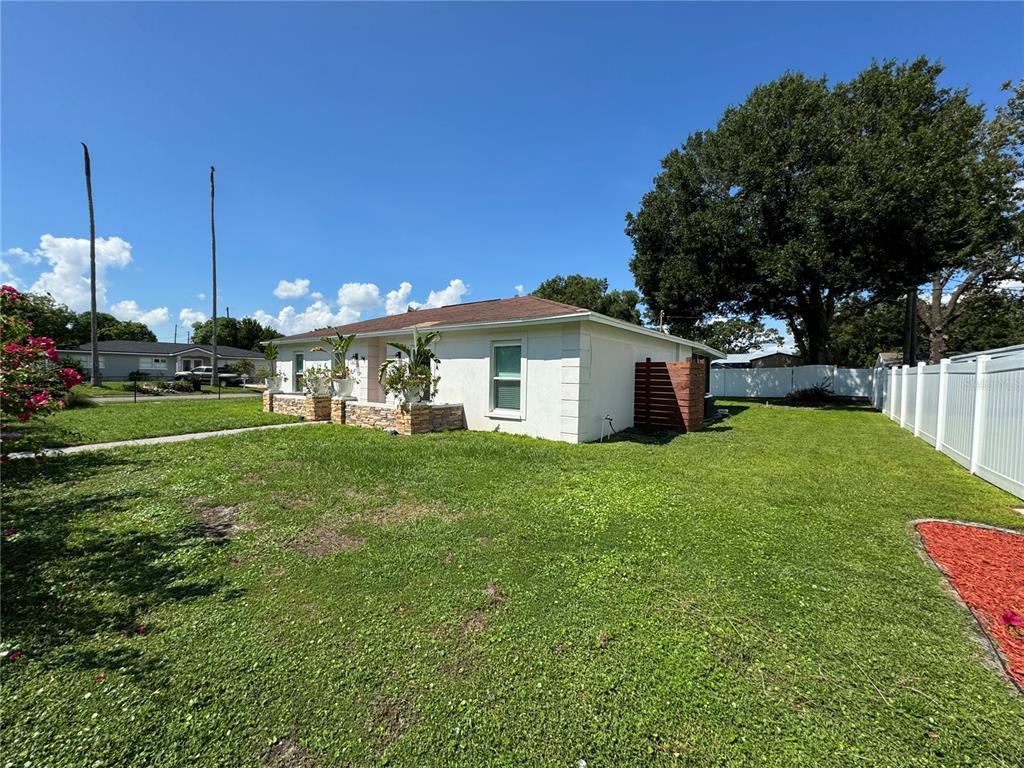 7102 Reindeer Road Tampa, FL 33619 - Photo 2 of 25 a bathroom with a sink yard and green space