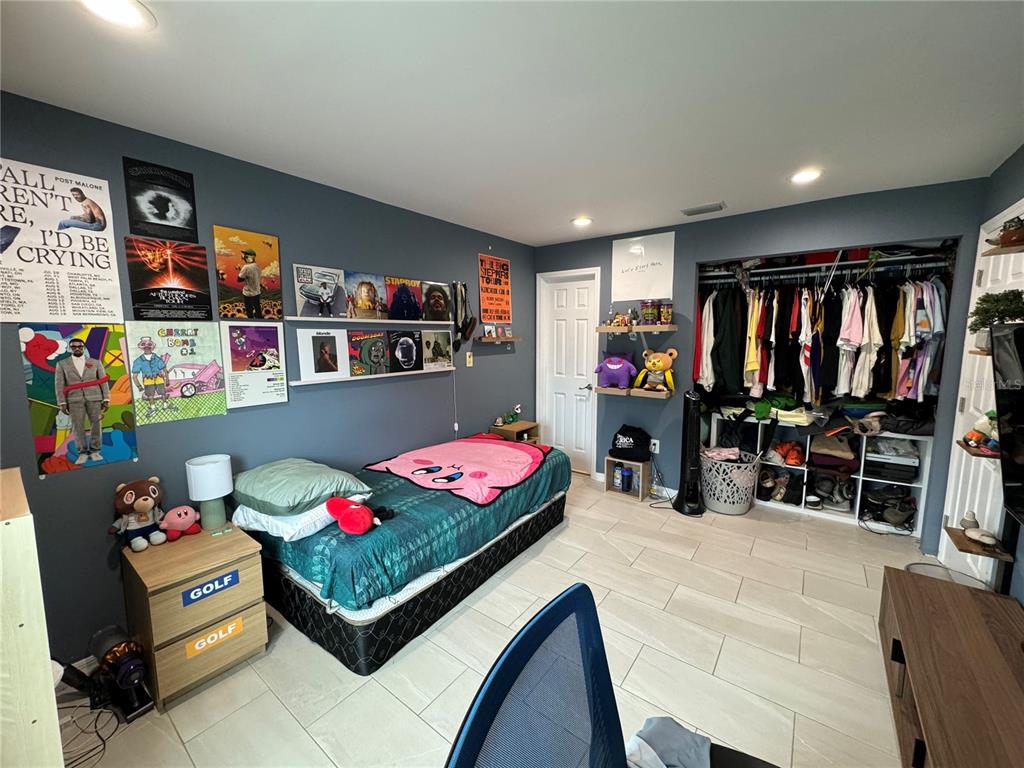 7102 Reindeer Road Tampa, FL 33619 - Photo 22 of 25 a bedroom with furniture and a bed