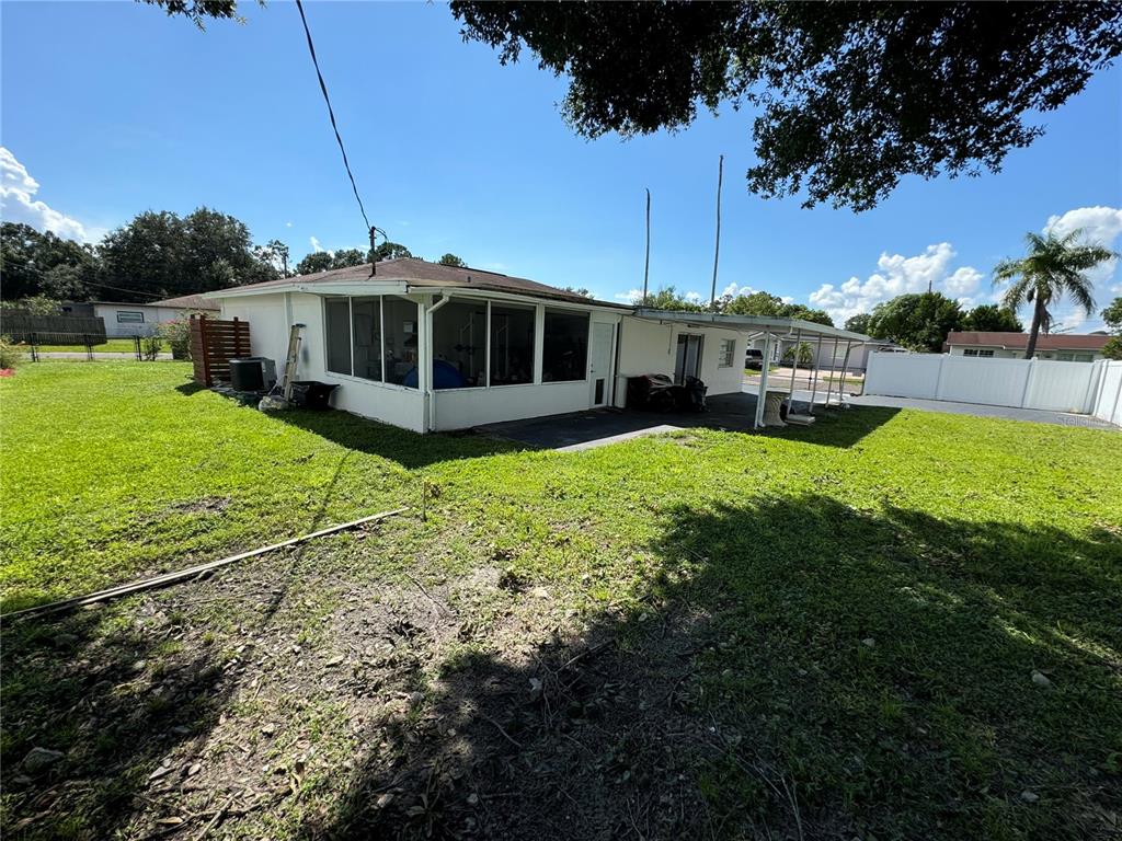 7102 Reindeer Road Tampa, FL 33619 - Photo 5 of 25 a white house with a big yard