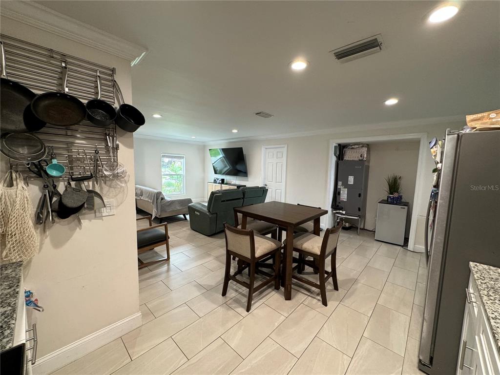 7102 Reindeer Road Tampa, FL 33619 - Photo 7 of 25 a view of a dining room with furniture and a chandelier