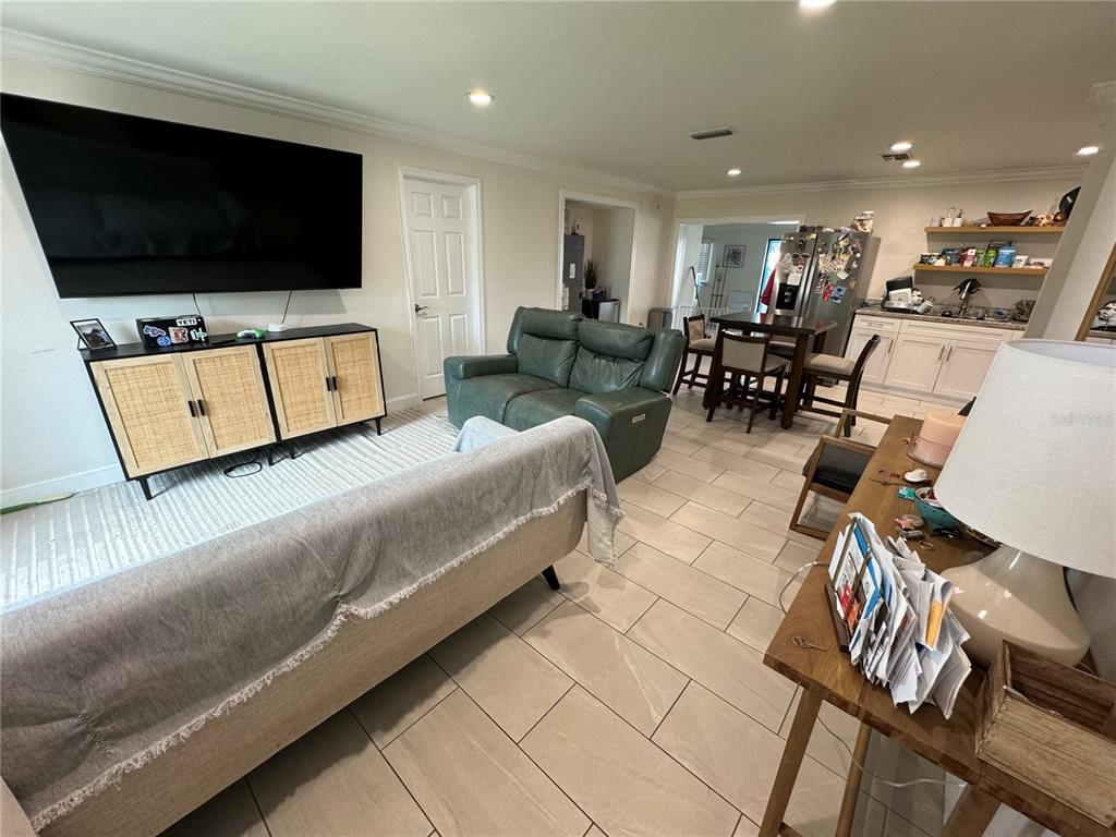 7102 Reindeer Road Tampa, FL 33619 - Photo 9 of 25 a living room with furniture and a flat screen tv