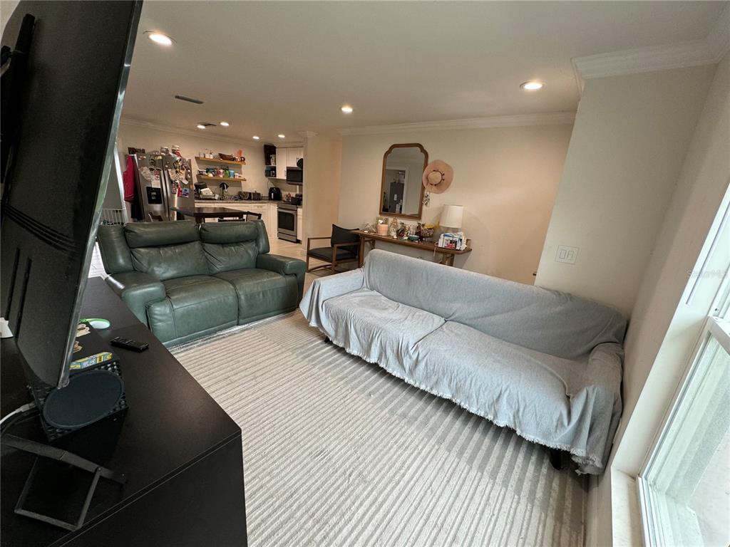 7102 Reindeer Road Tampa, FL 33619 - Photo 10 of 25 a living room with furniture and a flat screen tv