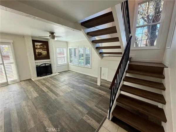 a view of a bedroom with wooden floor and staircase