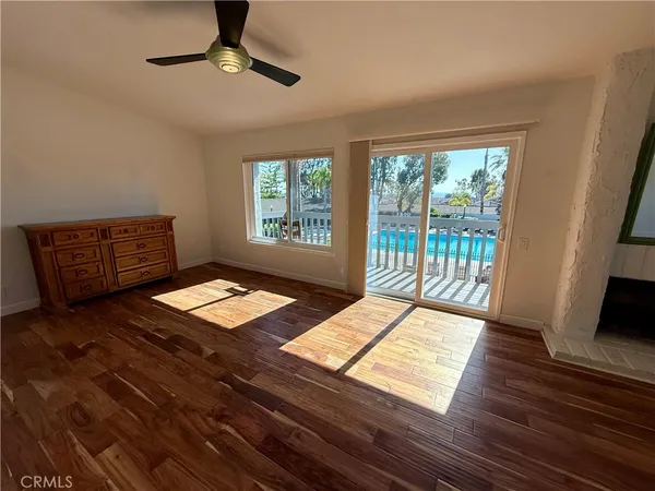 a very nice looking room with a large window and wooden floor