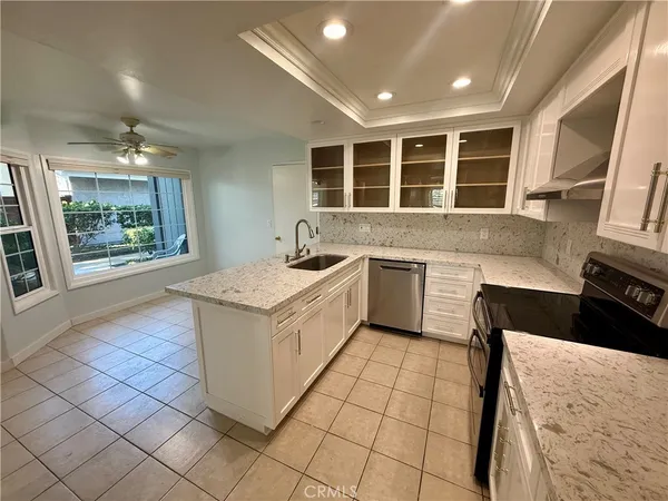 a kitchen with a stove sink and cabinets