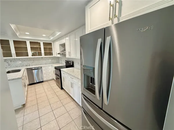 a kitchen with stainless steel appliances a refrigerator sink and cabinets