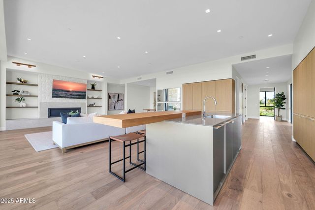 a spacious bedroom with a bed and a large window