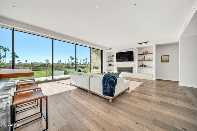 a table and chairs with potted plants in front of it
