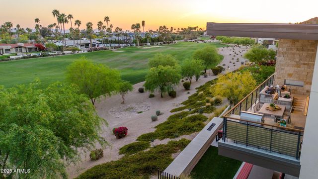 a living room with furniture a flat screen tv and a floor to ceiling window