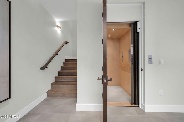 a spacious bedroom with a large bed and a large window with balcony view