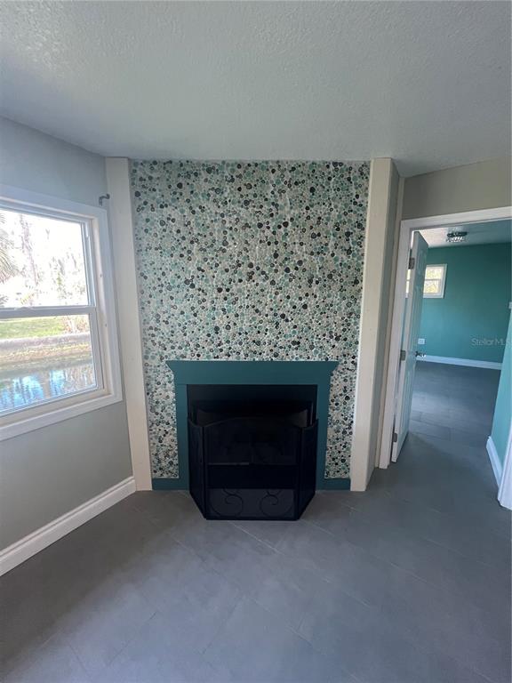7222 Tropical Drive Weeki Wachee, FL 34607 - Photo 14 of 23 a living room with a fireplace and a large window
