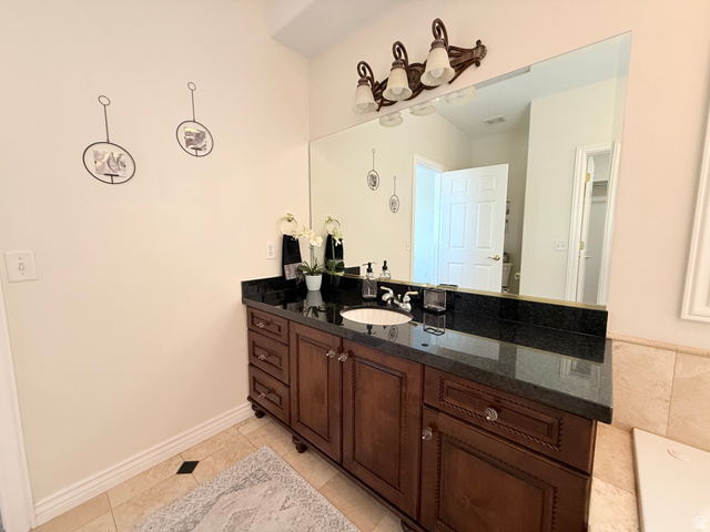 1562 Fairway Ridge Road Draper, UT 84020 - Photo 29 of 60 Bathroom vanity featuring a dark wood-finish cabinet with a granite countertop, undermount sink, and a large mirror