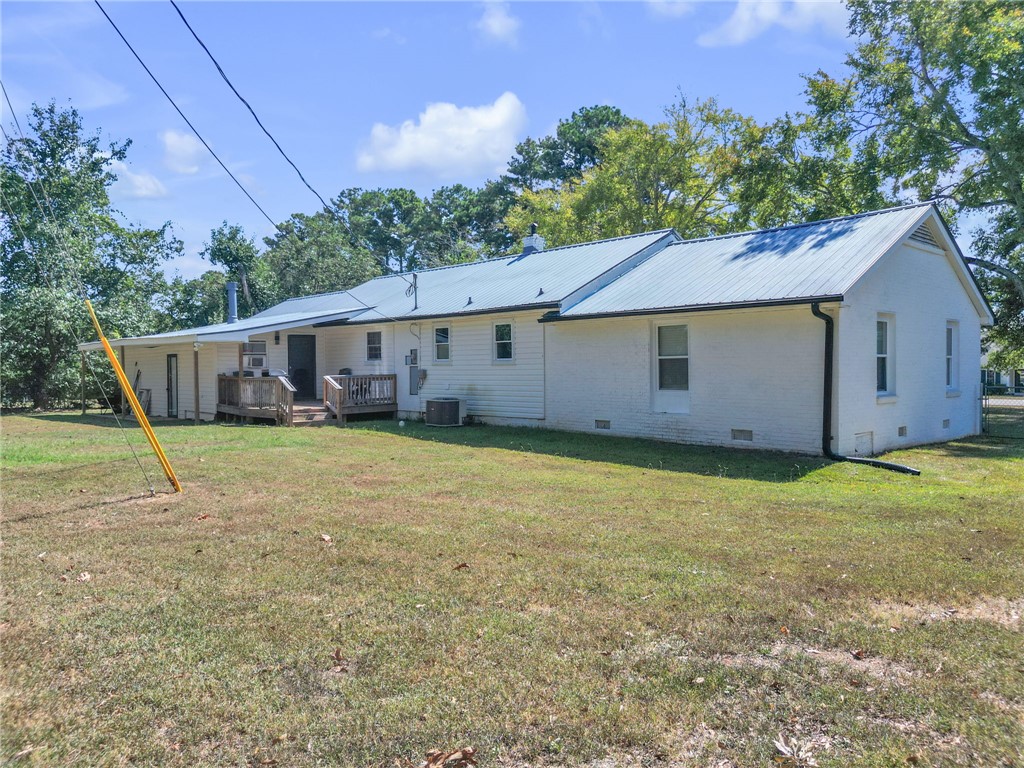 1048 Old Gantt Mill Road Anderson, SC 29625 - Photo 23 of 30 An expansive grassy backyard surrounds this single-story home with a durable metal roof.