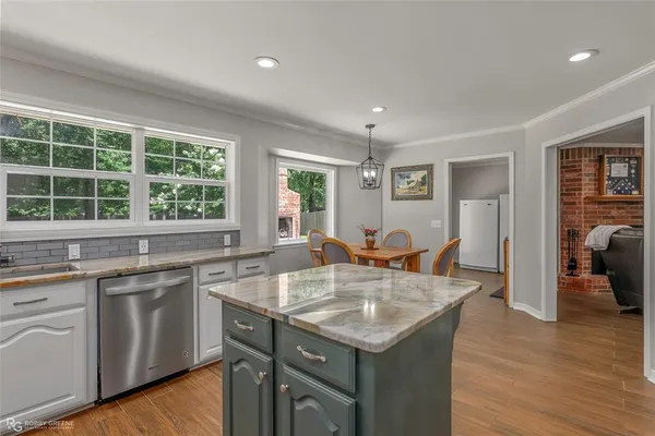 a kitchen with center island and windows