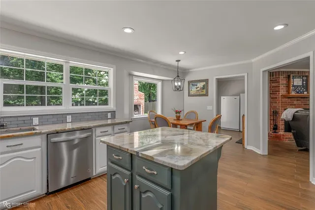 a kitchen with center island and windows