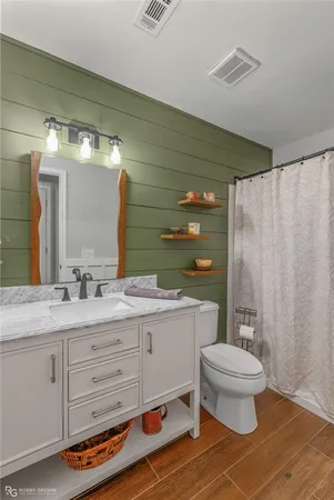 a bathroom with a double vanity sink toilet and a shower