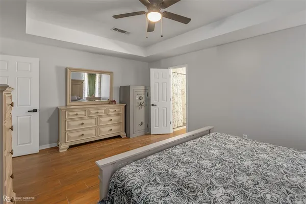a spacious bedroom with a bed and a cabinets