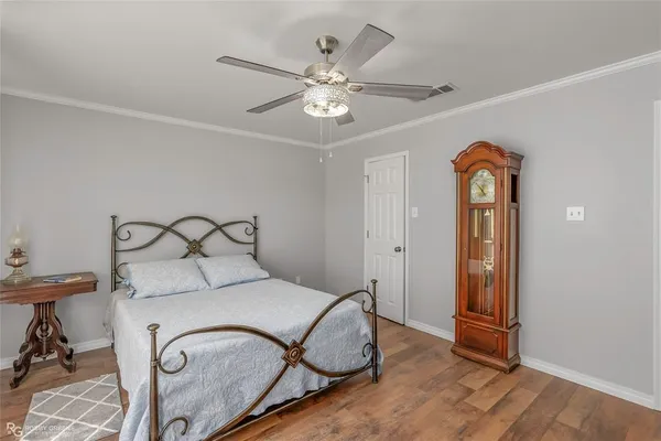 a bedroom with a bed and ceiling fan