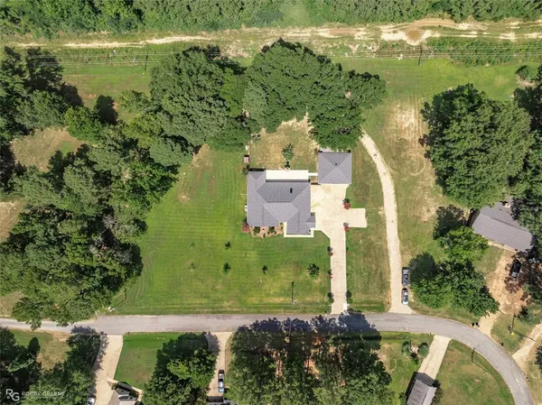 an aerial view of a house with a yard