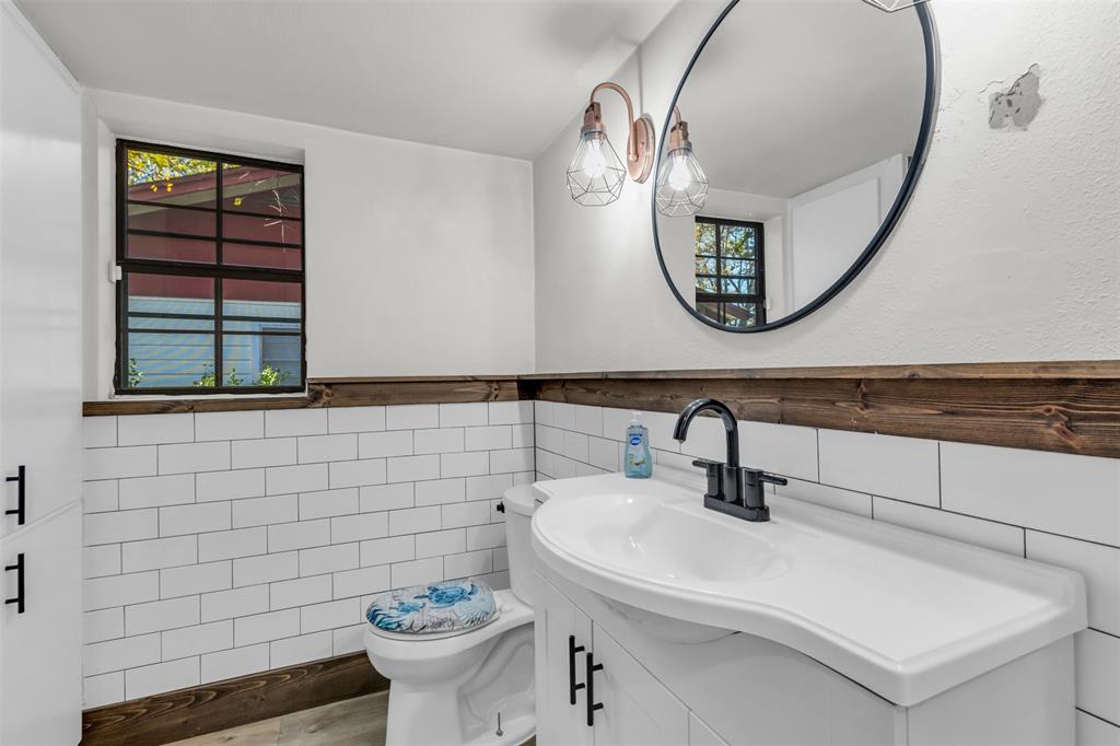 603 Lilly Street Cleburne, TX 76033 - Photo 20 of 30 Bathroom featuring plenty of natural light, vanity, and tile walls
