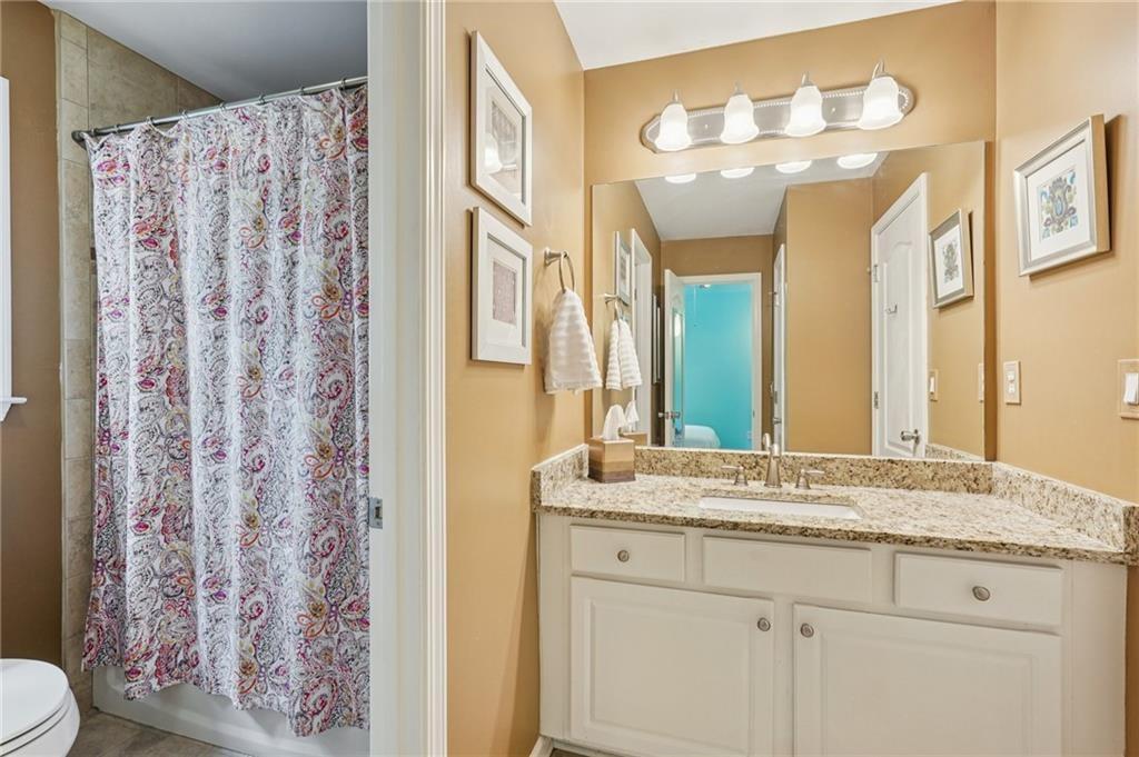 3820 Ridge Point Drive Suwanee, GA 30024 - Photo 37 of 41 a bathroom with a granite countertop sink and a mirror
