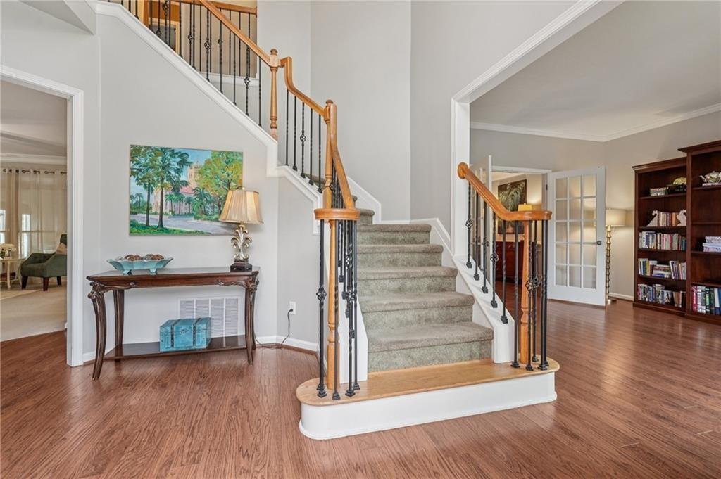 3820 Ridge Point Drive Suwanee, GA 30024 - Photo 5 of 41 a view of entryway and hall with wooden floor