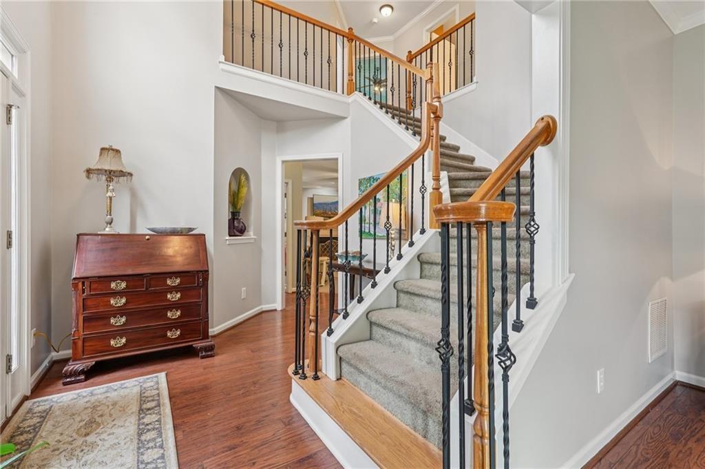 3820 Ridge Point Drive Suwanee, GA 30024 - Photo 6 of 41 a view of an entryway with wooden floor and door