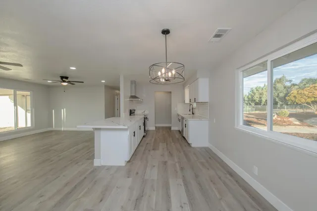 a view of a room with wooden floor and windows