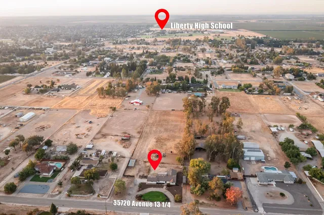 an aerial view of a house with garden space and street view