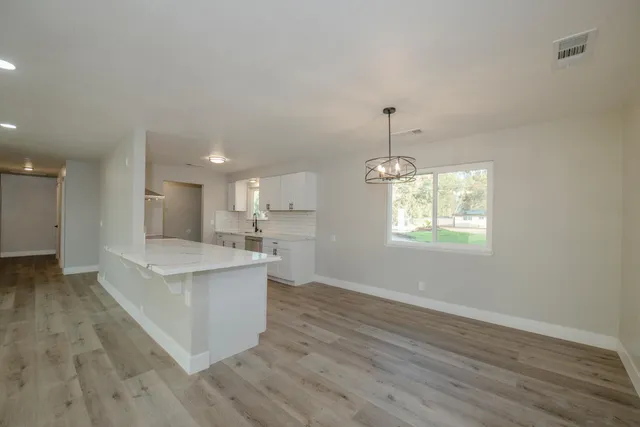 a view of kitchen with sink and wooden floor