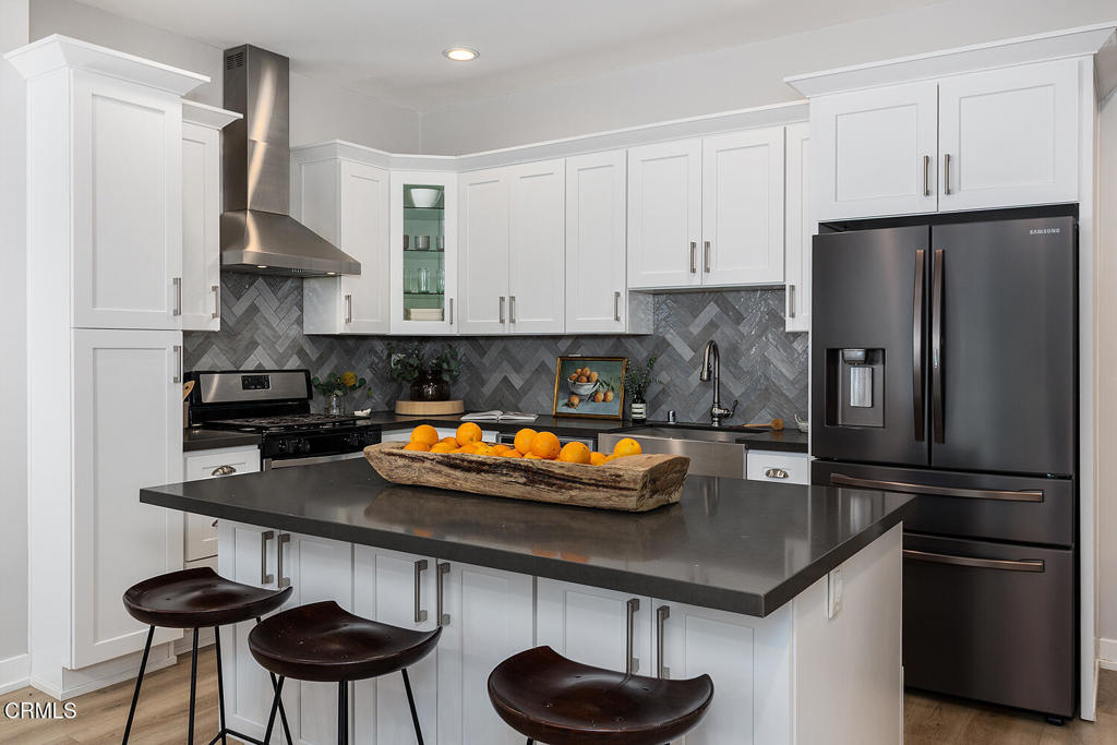 2040 North Madison Avenue Altadena, CA 91001 - Photo 11 of 35 a kitchen with stainless steel appliances a sink a refrigerator and a stove