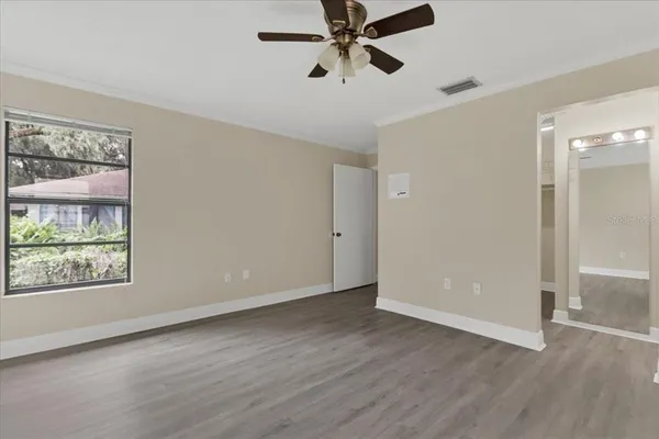 wooden floor in an empty room with a window