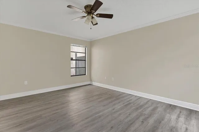 an empty room with a painting on the wall