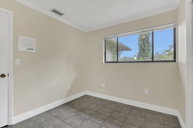 an empty room with windows and closet