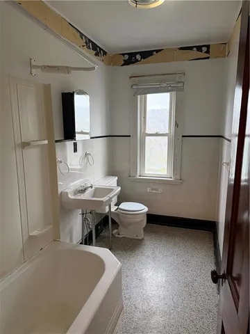 a view of a hallway with wooden shelves