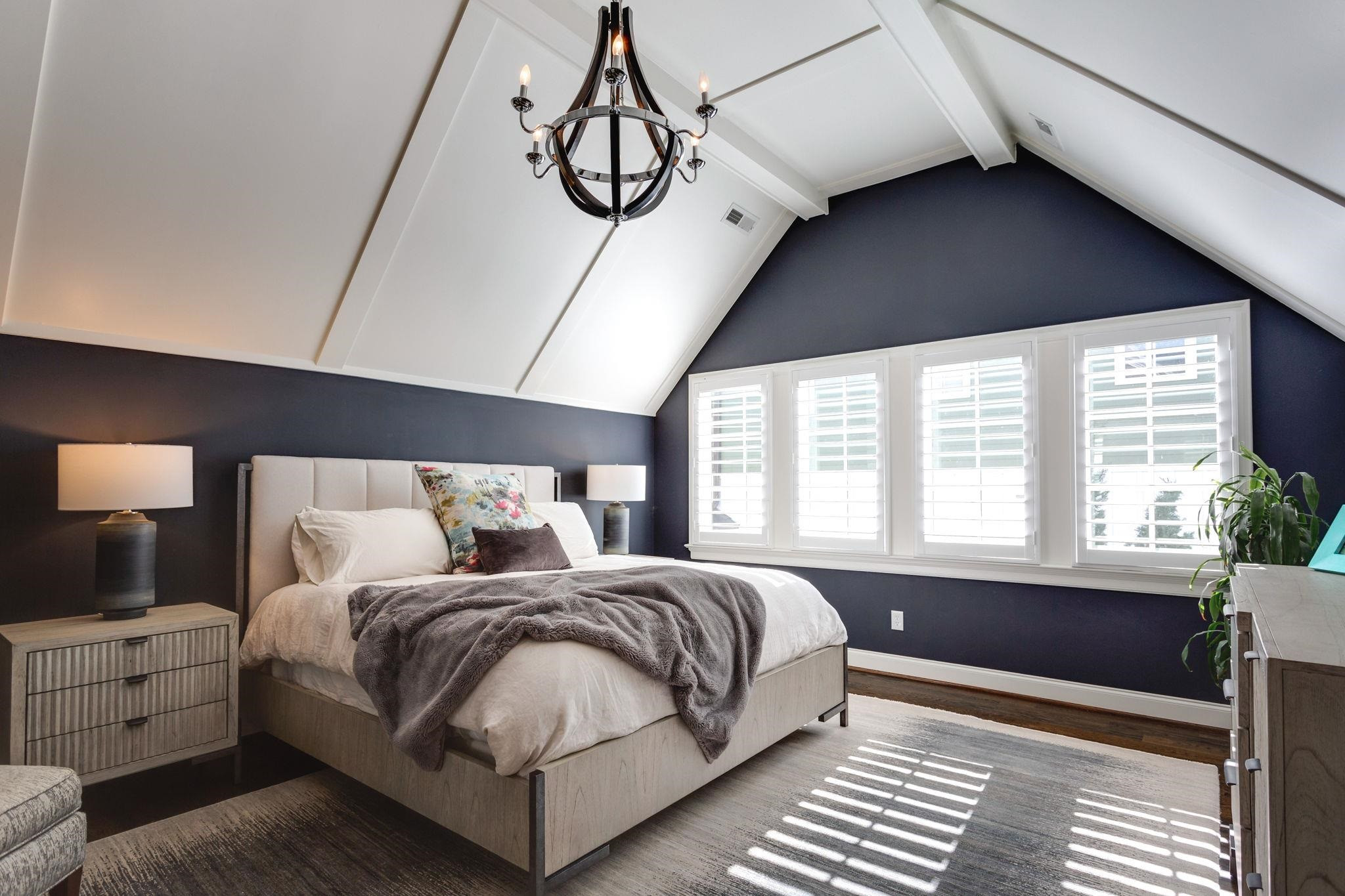 2008 Vinnings Place Raleigh, NC 27608 - Photo 25 of 55 a spacious bedroom with a bed and a chandelier