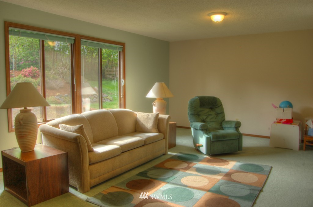 18731 129th Court Northeast Bothell, WA 98011 - Photo 11 of 24 a living room with furniture and a lamp