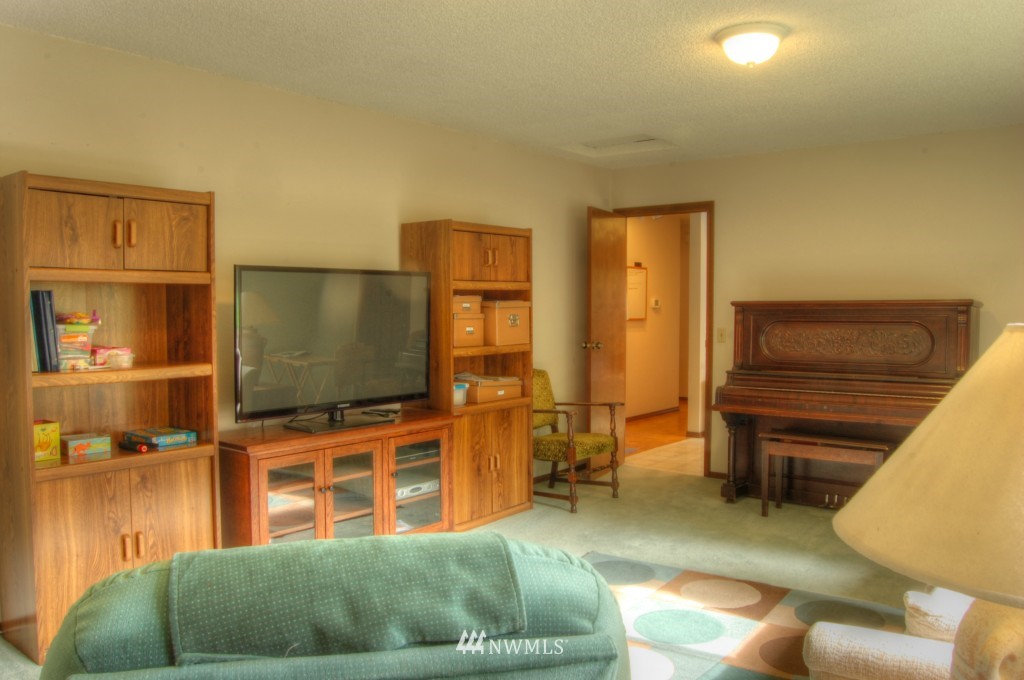 18731 129th Court Northeast Bothell, WA 98011 - Photo 12 of 24 a living room with furniture and a flat screen tv