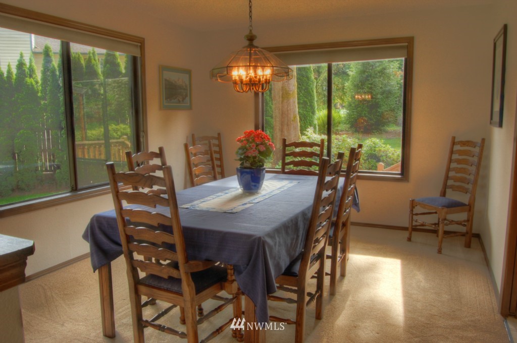 18731 129th Court Northeast Bothell, WA 98011 - Photo 14 of 24 a view of a dining room with furniture window and outside view
