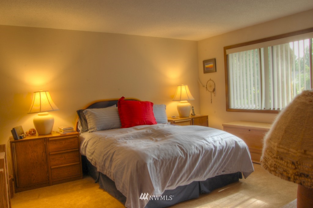 18731 129th Court Northeast Bothell, WA 98011 - Photo 19 of 24 a bedroom with a bed and a lamp